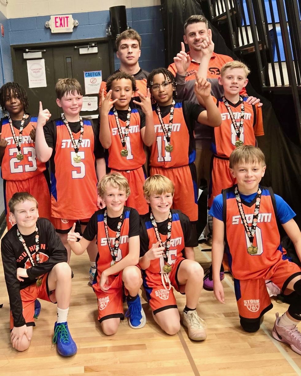 Storm Basketball players celebrating a championship with medals